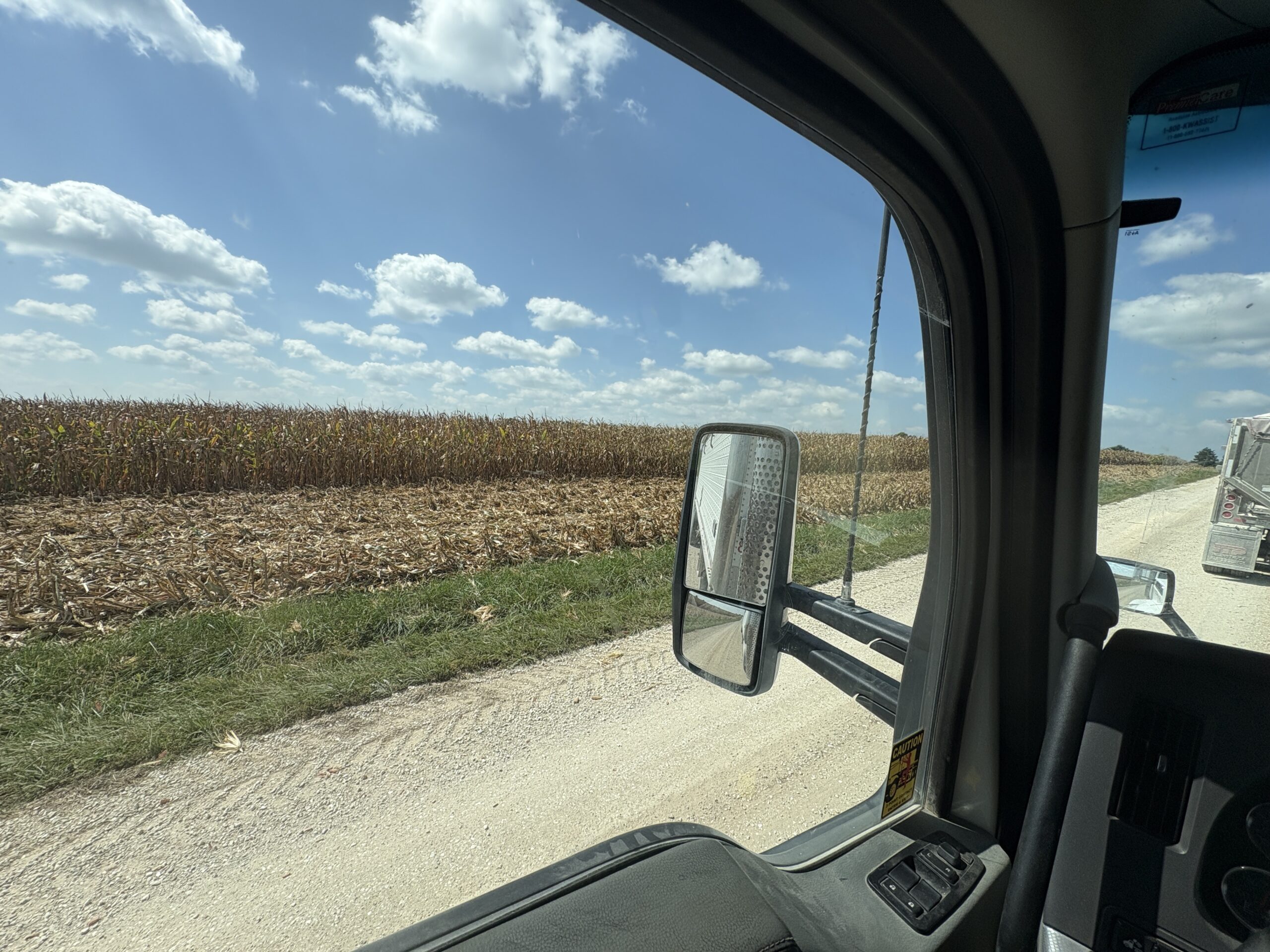 Narrow gravel road and hauling corn