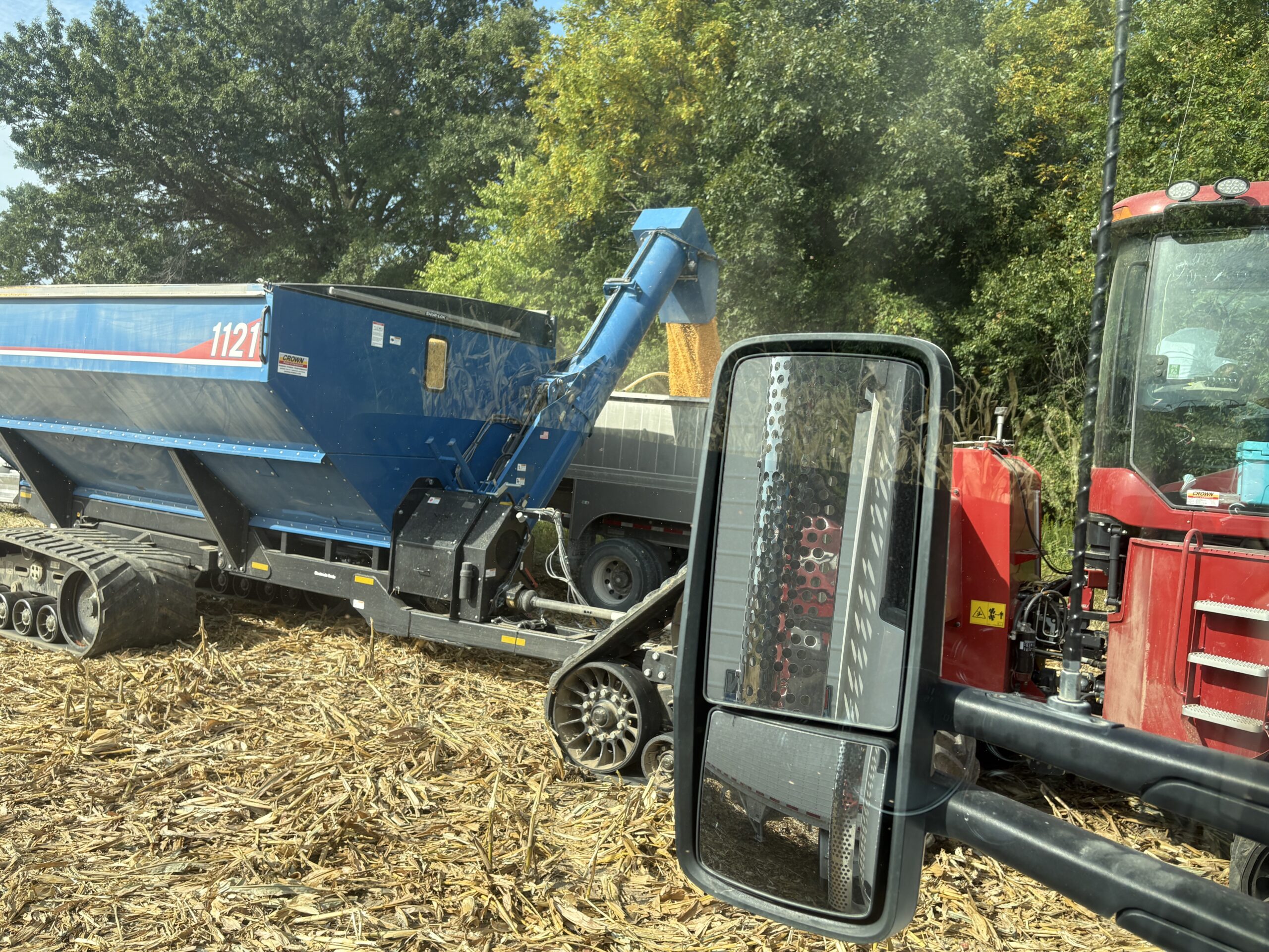 Grain cart filling semi truck end dump trailer