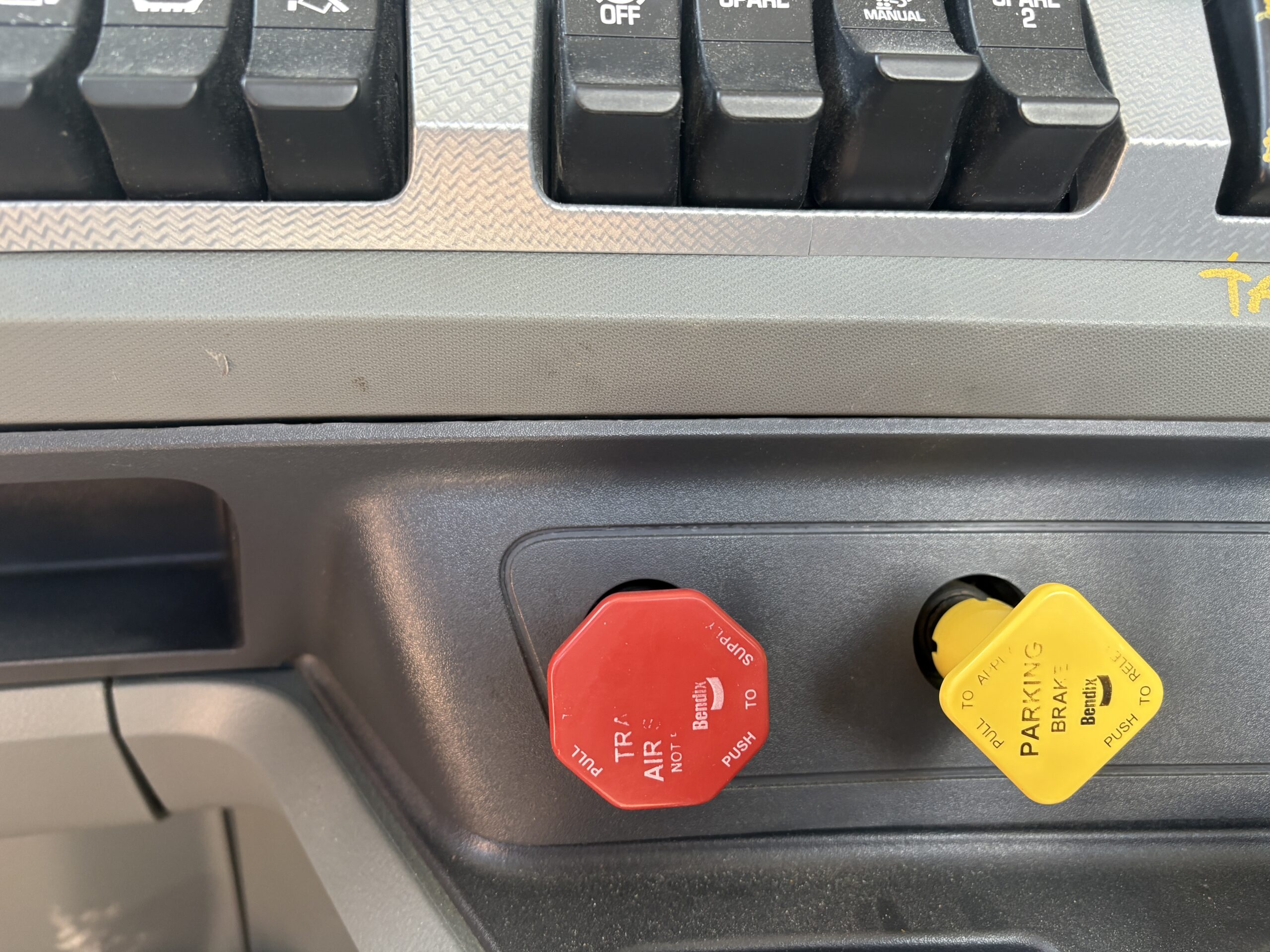 Air brake controls inside semi tractor cab 