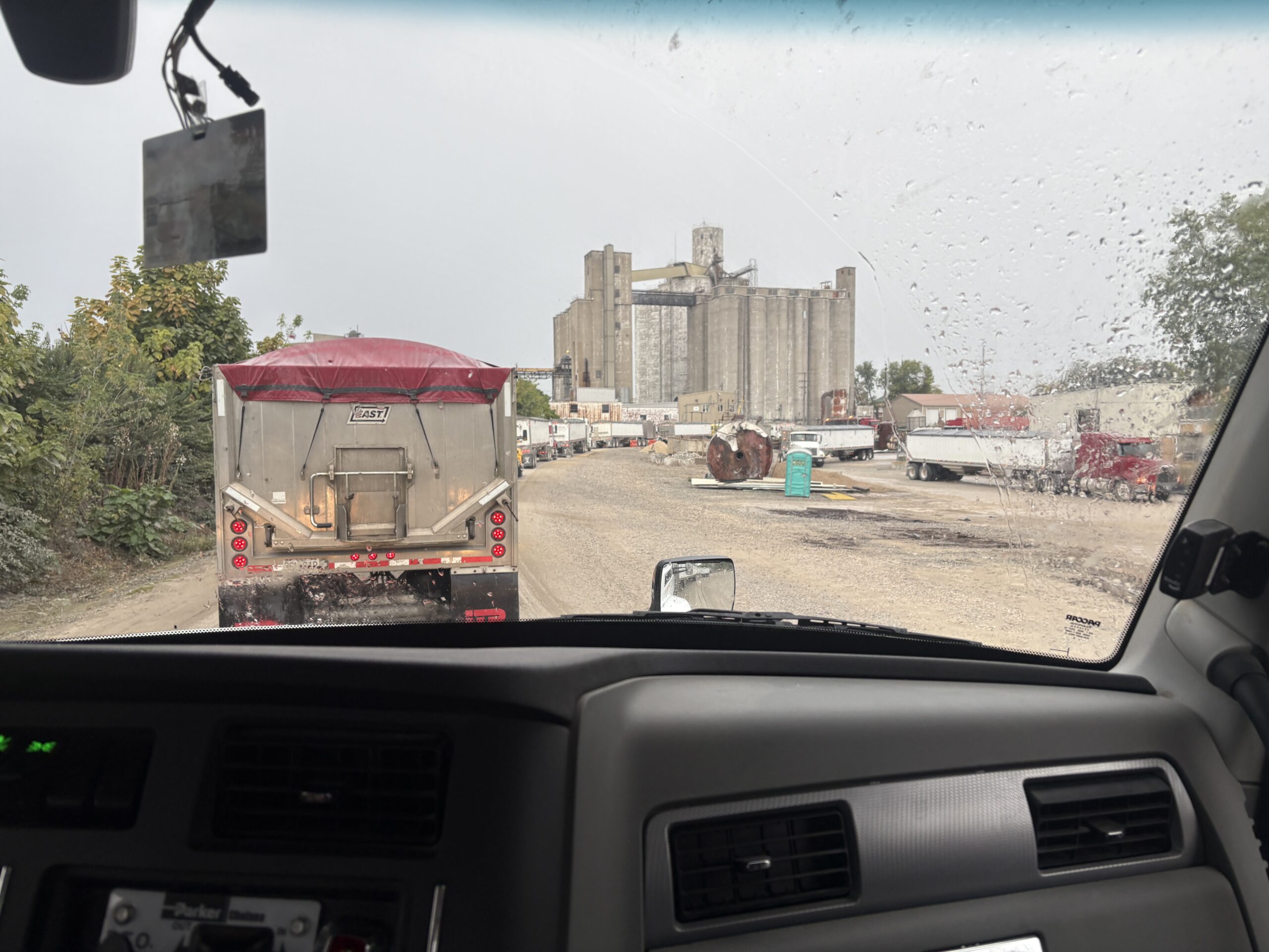 Long line of bean loaded trucks waiting at ADM grain elevator